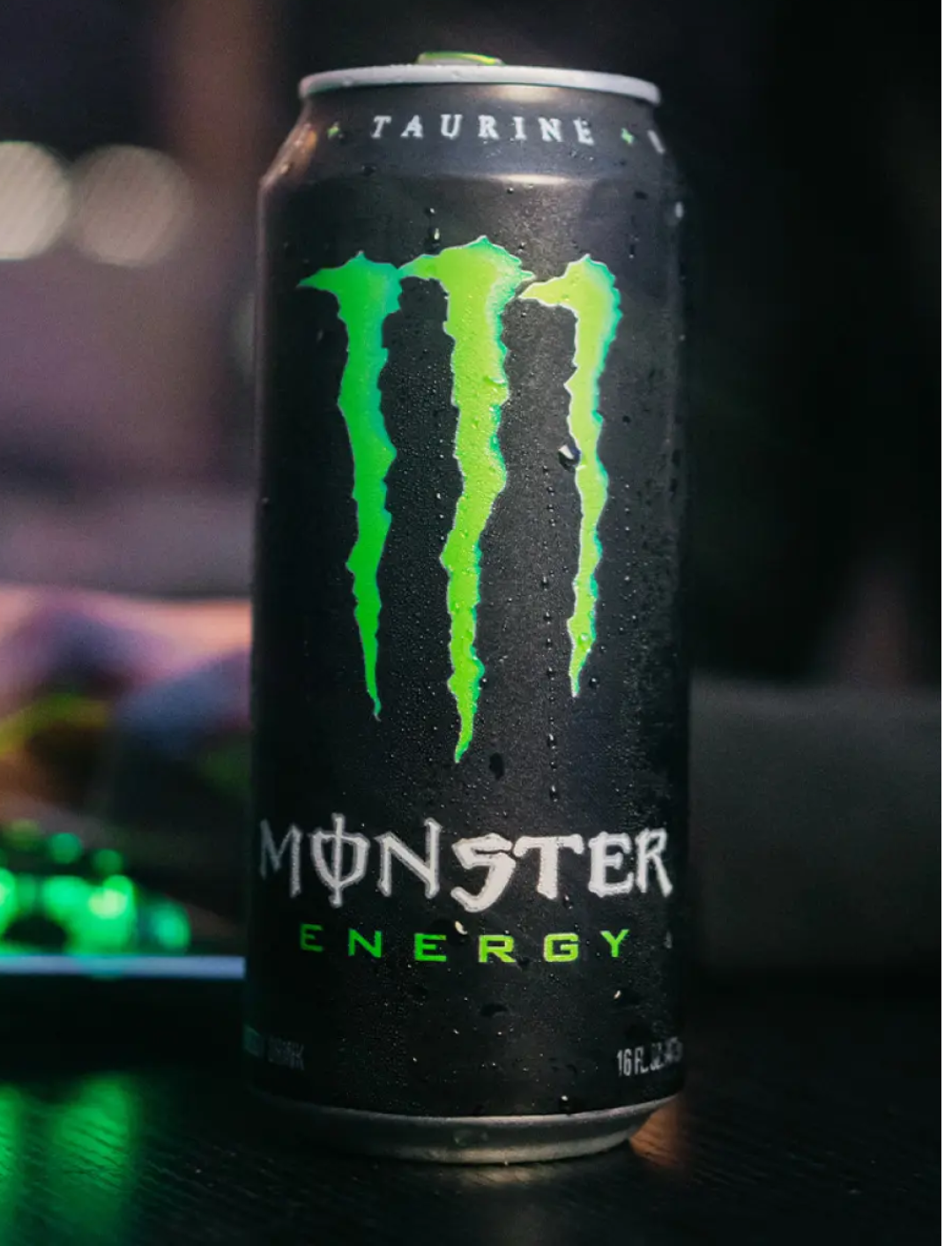 Monster Energy drink can with green logo on a dark background